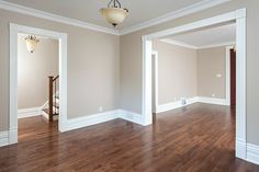 an empty living room with hard wood floors and white trim on the walls is shown