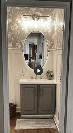 a bathroom with a mirror, sink and toiletries on the door way to another room