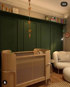 a baby's room with green walls and furniture