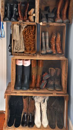 a wooden shelf filled with lots of boots