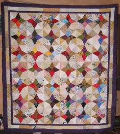 a large quilt is hanging on the wall