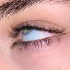 a woman's blue eye with long lashes