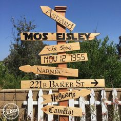 a wooden sign that has many different signs on it