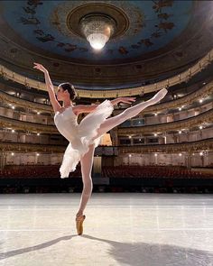 a ballerina is in the middle of an ice skating rink