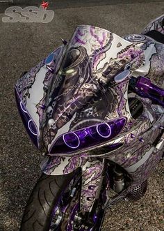 a purple and white motorcycle parked on the street