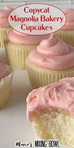 cupcakes with pink frosting sitting on a white plate next to each other