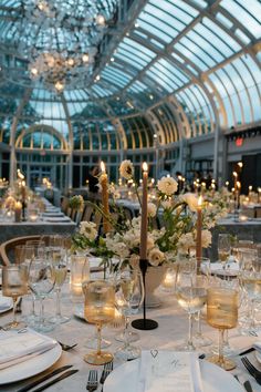 a table set for an event with candles and flowers