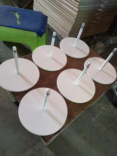 four white plates with forks on them are sitting on a table in front of stacks of cardboard boxes