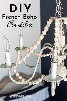 a white chandelier hanging from a ceiling in a room with text overlay that reads diy french boho chandelier