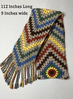 a multicolored crocheted blanket with fringes on it and the words, 12 inches long 9 inches wide