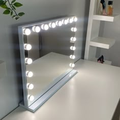 a vanity mirror with lights on top of it