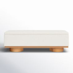 an upholstered bench with wooden legs on a white background in front of a wall