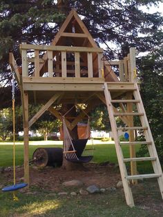 a wooden play structure with a ladder and sign that says interest