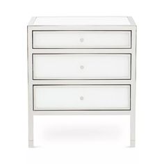 a white dresser with three drawers on it