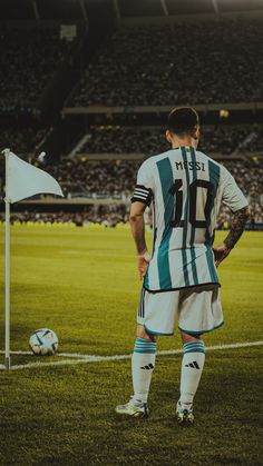 a man standing on top of a field next to a soccer ball