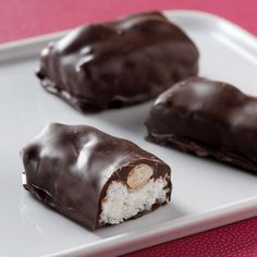 three pieces of chocolate on a white plate