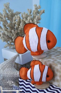 two stuffed clown fish sitting on top of a table