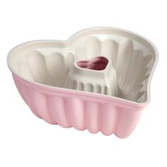 a pink heart shaped dish on a white background