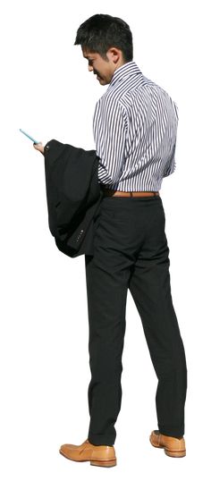 a man in striped shirt and black pants looking at his cell phone while holding a bag