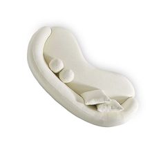 the pillow is shaped like a long, curved couch with pillows on it's sides