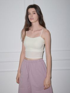 This tank top is a versatile item that can be styled with any bottom and be layered with any shirts or outers, exuding basic and modern mood.- Available in 2 basic colors: white and black- Features a built-in chest cap for added style- Made from a soft and stretchy fabric blend of cotton and spandex Casual Tops With Built-in Bra And Spaghetti Straps, Fitted Camisole With Built-in Bra For Summer, Casual Loungewear Tops With Built-in Bra, Casual Tops With Built-in Bra For Day Out, Seamless Crop Top For Summer Layering, Summer Layering Tank Strap Crop Top, Basic Cotton Tops With Built-in Bra, Versatile Cotton Crop Top For Layering, Spaghetti Strap Tops With Built-in Bra For Day Out