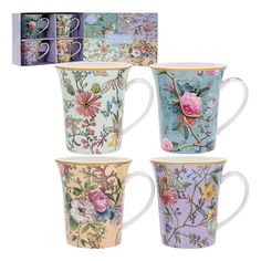 four coffee mugs with floral designs on them and two boxed boxes in the background