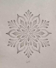 a drawing of a snowflake made out of small circles and dots on white paper