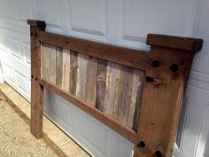 a wooden headboard hanging on the side of a garage door