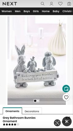 an image of two bunny figurines sitting on top of a bed next to each other