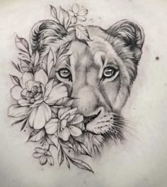 a lion with flowers in its mouth on the back of a woman's shoulder