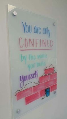 a sign on the wall that says you are only confined by the walls you build yourself