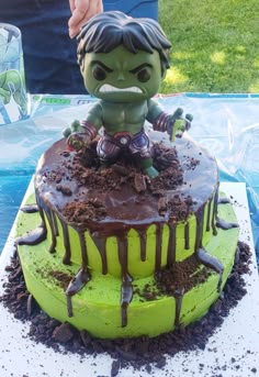 there is a cake that looks like the incredible hulk - man on top of it