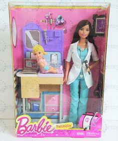 the barbie doll is playing with her kitchen set