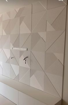 the wall is decorated with white geometric designs