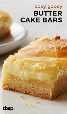 a close up of a piece of cake on a plate with the words booey gooey butter cake bars