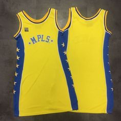 two yellow and blue basketball jerseys sitting next to each other