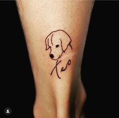 a small dog tattoo on the foot of a person's leg, which is drawn in black ink