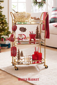 a gold serving cart with christmas decorations on it