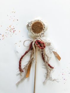 an odd looking object is sitting on top of some sticks and sprinkles