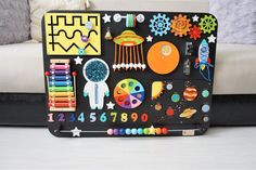 a black tray with magnets and toys on it