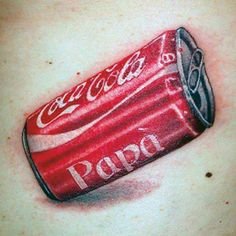 a man's chest with a tattoo of a can of coca - cola on it