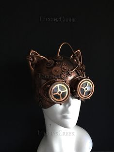 Crafted with meticulous detail, this women's masquerade mask fuses the whimsy of a cat with the intrigue of steampunk. Intricate gears and tubes create a mesmerizing spectacle, reflecting the steampunk aesthetic. The goggles detail adds mystery and adventure to your appearance. Leave everyone captivated by your feline presence at any Halloween party or cosplay event! Age Group/Gender - Adult/Women Size/Type - One size fits all adults Mask Color - Copper Mask Material - Polyresin Accent Material Steampunk Face Mask, Led Lights Party, Masquerade Mask Women, Festival Mask, Led Light Mask, Masquerade Ball Masks, Purple Led Lights, Scary Halloween Masks, Mask Light