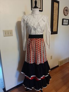 "Mid Century Womens Red/White Blue Tiered Neusteters Peasant Skirt Size S Very Good Vintage Condition. Shows Very Little Wear. No Rips Or Tears. 3 Small Light Red Stains. Appear To Be Insect Residue. All Lightened With Damp Cloth And Small Amount Of Stain Spray. Should Come Out when Cleaned. No Content Label, Tag That Says Dry Clean Only Appears To Be 100% Cotton But Could Have Some Polyester In It Navy Blue 2.5\" Waistband That Ties In Back Red/White/Blue Geometric Print Two 10\" Navy Blue With Retro Fitted White Skirt, White Fitted Ruffled Maxi Skirt, Red Ruffled Cotton Skirt, Red Fitted Cotton Maxi Skirt, Fitted Red Cotton Maxi Skirt, Red Fitted Maxi Skirt With Ruffles, Vintage White Lined Skirt, White Retro Cotton Skirt, Vintage White Pleated Skirt