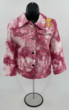 a pink and white tie dye jacket on a mannequin's head stand