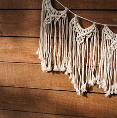 there are many tassels hanging on the wooden wall with no one around them