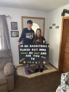 two people holding a sign that says i'm no basketball player but imma shoot my shot and ask you to prom