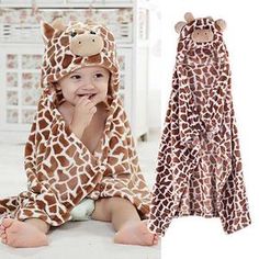 a baby wearing a giraffe robe and hat