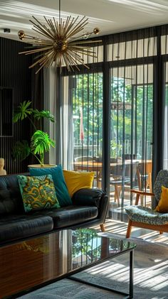 a living room filled with furniture and lots of glass doors leading to an outside patio