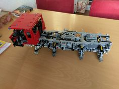 a lego train sitting on top of a wooden table