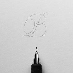 a pencil drawing the letter b on white paper